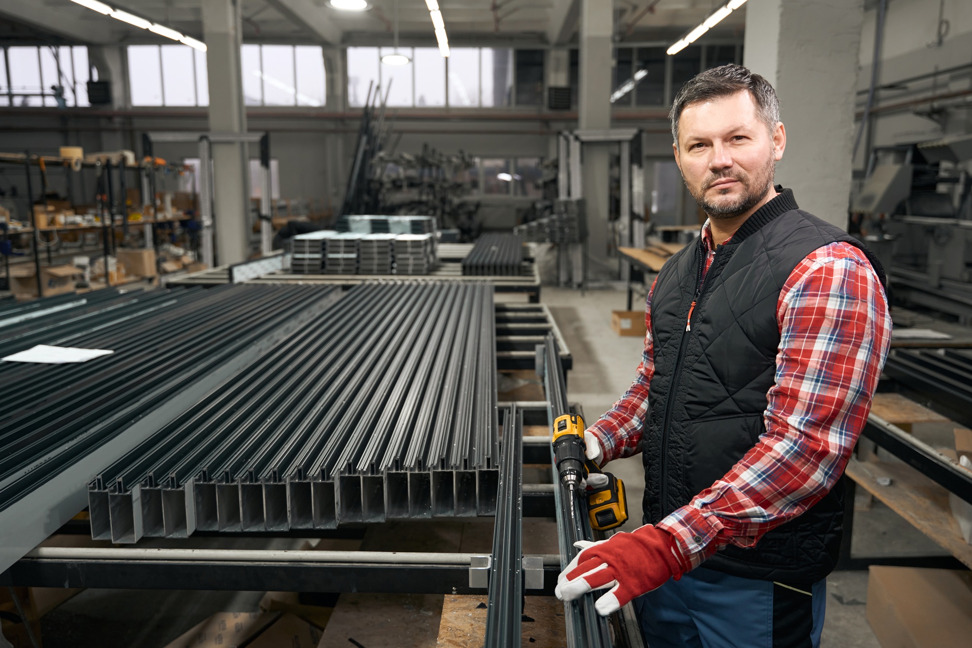 Adult man standing next to metal structure