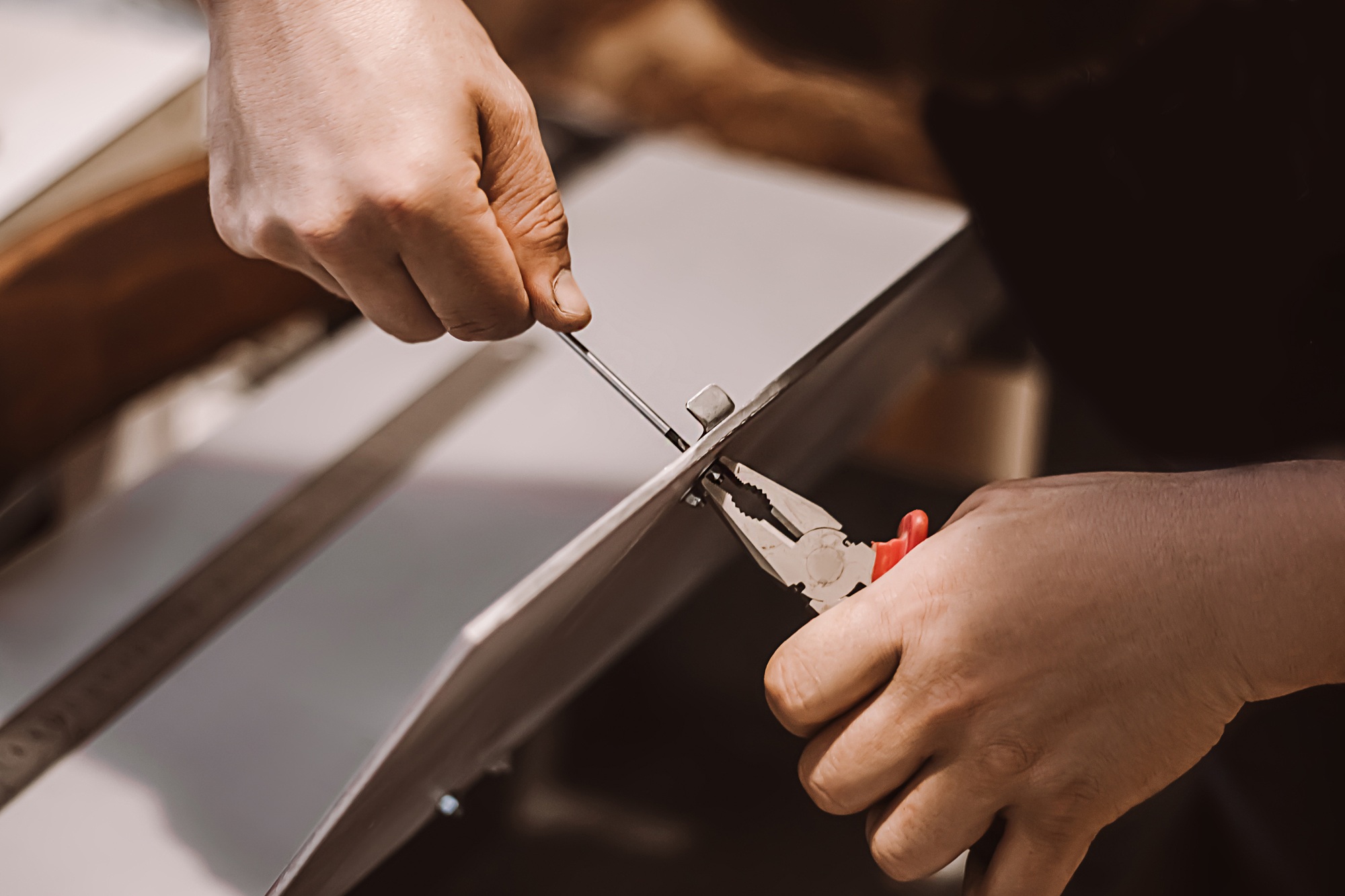 Furniture assembler mechanic works with screwdriver.